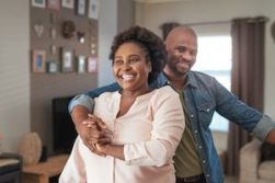 Move Your Body - Couple laughing as they dance in their living room